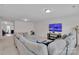 Bright and airy living room featuring a comfortable gray sectional and entertainment center at 117 Langhorne Dr, Mount Holly, NC 28120