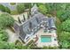 An aerial view of a home with a large slate roof, pool, and lush landscaping at 11710 Ney Manor Way, Charlotte, NC 28277