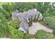 An aerial view of a luxury home featuring a slate roof, well-maintained landscaping, and a circular paver driveway at 11710 Ney Manor Way, Charlotte, NC 28277