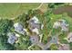 An aerial view showing a large home with a pool, outlined in red, situated on a well-manicured lot near a pond at 11710 Ney Manor Way, Charlotte, NC 28277