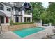 The back of the house shows a swimming pool, stone wall, and outdoor living space at 11710 Ney Manor Way, Charlotte, NC 28277