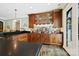 Home bar area with custom wood cabinets, granite countertop, mirrored backsplash, and ample liquor storage at 11710 Ney Manor Way, Charlotte, NC 28277