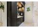 Bathroom features a dark wood vanity with marble countertop, storage cabinets, decorative mirror, and tiled floor at 11710 Ney Manor Way, Charlotte, NC 28277