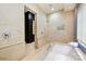 Elegant bathroom boasts marble tile, a soaking tub, walk-in shower, and a view into the vanity room at 11710 Ney Manor Way, Charlotte, NC 28277