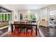 Dining room with large table, wood floors, and a view to the office at 11710 Ney Manor Way, Charlotte, NC 28277