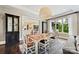 Bright dining room with large windows, decorative cabinet and a view to the kitchen at 11710 Ney Manor Way, Charlotte, NC 28277