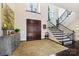 Grand foyer featuring a staircase, dark hardwood floors, and a decorative console table at 11710 Ney Manor Way, Charlotte, NC 28277