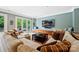 Inviting living room with comfortable seating, large TV, and access to the outdoor patio with French doors at 11710 Ney Manor Way, Charlotte, NC 28277