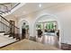 Spacious living room with dark hardwood floors, arched doorways, and ample natural light at 11710 Ney Manor Way, Charlotte, NC 28277