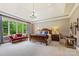 Spacious main bedroom with tray ceiling, chandelier, large windows, and sitting area with red settee at 11710 Ney Manor Way, Charlotte, NC 28277