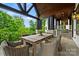 Covered outdoor patio with dining area and stainless steel grill at 11710 Ney Manor Way, Charlotte, NC 28277