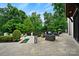 Outdoor patio with stone flooring, comfortable seating, lush landscaping, and a small plunge pool at 11710 Ney Manor Way, Charlotte, NC 28277