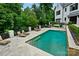Backyard pool area with lounge chairs and lush landscaping at 11710 Ney Manor Way, Charlotte, NC 28277