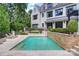 Backyard pool with stone retaining wall and steps to a patio with outdoor furniture at 11710 Ney Manor Way, Charlotte, NC 28277