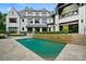 A luxurious pool with manicured hedges and a large backyard at 11710 Ney Manor Way, Charlotte, NC 28277