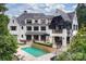 Large backyard features an in-ground pool and outdoor living spaces, perfect for entertaining at 11710 Ney Manor Way, Charlotte, NC 28277
