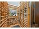Climate-controlled wine cellar with custom wood racking, bottle storage, and tasting area at 11710 Ney Manor Way, Charlotte, NC 28277