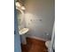 Stylish half bathroom with hardwood floors, pedestal sink, and modern fixtures at 129 Steinbeck Way, Mooresville, NC 28117