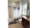 Full bathroom with a shower-tub combination, vanity with a granite countertop, and warm-toned tile flooring at 129 Steinbeck Way, Mooresville, NC 28117