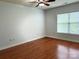 Serene bedroom with hardwood floors, a ceiling fan, and a bright window at 129 Steinbeck Way, Mooresville, NC 28117