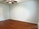 Bright bedroom featuring hardwood floors, a ceiling fan, and neutral paint, creating a welcoming space at 129 Steinbeck Way, Mooresville, NC 28117