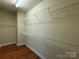 Walk-in closet with built-in wire shelving providing ample storage space, complemented by hardwood floors at 129 Steinbeck Way, Mooresville, NC 28117