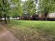 Lush green lawn and mature trees adorn this townhome community at 129 Steinbeck Way, Mooresville, NC 28117