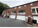 Long row of brick townhomes with garages and rear balconies at 129 Steinbeck Way, Mooresville, NC 28117