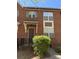 Charming brick townhome with awning and landscaped yard at 129 Steinbeck Way, Mooresville, NC 28117