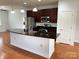 Well-equipped kitchen with dark cabinetry, granite countertops, and stainless steel appliances at 129 Steinbeck Way, Mooresville, NC 28117