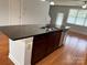 Spacious kitchen island featuring a sink, storage, and a sleek granite countertop at 129 Steinbeck Way, Mooresville, NC 28117