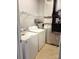 Functional laundry room with washer, dryer, shelving, and updated mechanicals, blending efficiency and utility at 129 Steinbeck Way, Mooresville, NC 28117