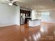 Open-concept living and kitchen with stainless steel appliances and hardwood floors at 129 Steinbeck Way, Mooresville, NC 28117