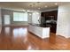 Open-concept kitchen and living room featuring hardwood floors and stainless steel appliances at 129 Steinbeck Way, Mooresville, NC 28117