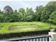 Scenic view of a lush pond surrounded by green trees and landscaping at 129 Steinbeck Way, Mooresville, NC 28117