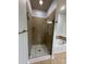 Elegant shower enclosure with glass door and neutral tile, complemented by a bathtub, offering a spa-like experience at 129 Steinbeck Way, Mooresville, NC 28117