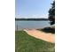 Scenic view of a lake with a sandy beach and clear blue water on a sunny day at 134 Crystal Cir, Mooresville, NC 28117
