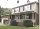 Inviting brick home with a covered front porch, mature landscaping, and classic architectural details at 134 Crystal Cir, Mooresville, NC 28117