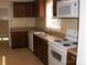 Traditional kitchen featuring wood cabinets, white appliances and tiled flooring for easy maintenance at 134 Crystal Cir, Mooresville, NC 28117