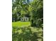 Side exterior of the home showing the yard and natural light at 134 S Jackson Rd, Lancaster, SC 29720
