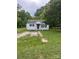 Exterior view of a one-story home with a gravel driveway and black shutters at 134 S Jackson Rd, Lancaster, SC 29720