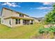 Backyard with lush lawn, screened porch, adjacent property, fire pit and mature landscaping at 1355 Cilantro Ct, Fort Mill, SC 29708