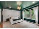 Stylish bedroom with a decorative wall, large windows, and an overhead light fixture at 1355 Cilantro Ct, Fort Mill, SC 29708