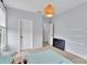 This bedroom boasts neutral carpeting, complemented by soft blue walls, an open closet, and a uniquely designed ceiling light fixture at 1355 Cilantro Ct, Fort Mill, SC 29708