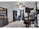 Bedroom with ceiling fan, a mounted monitor, dark wood furniture, neutral carpeting and grey-blue walls at 1355 Cilantro Ct, Fort Mill, SC 29708