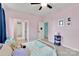 This bedroom is painted pink and features a metal frame bed and a large window with navy blue curtains at 1355 Cilantro Ct, Fort Mill, SC 29708
