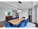 Elegant dining room with a modern chandelier, large windows, and seating for eight at 1355 Cilantro Ct, Fort Mill, SC 29708