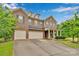 Charming brick home featuring a three car garage, inviting front porch, and well-manicured landscaping at 1355 Cilantro Ct, Fort Mill, SC 29708