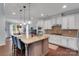 Open kitchen with granite counters, stainless appliances, and a kitchen island with bar seating at 1355 Cilantro Ct, Fort Mill, SC 29708