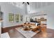 Bright living room open to the kitchen with large windows and hardwood flooring at 1355 Cilantro Ct, Fort Mill, SC 29708